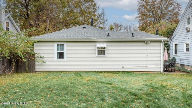 back of property featuring a lawn