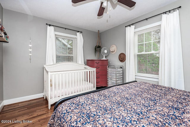 bedroom with dark wood-type flooring and ceiling fan