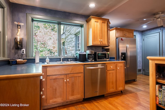 kitchen with ceiling fan, sink, light hardwood / wood-style floors, and stainless steel appliances