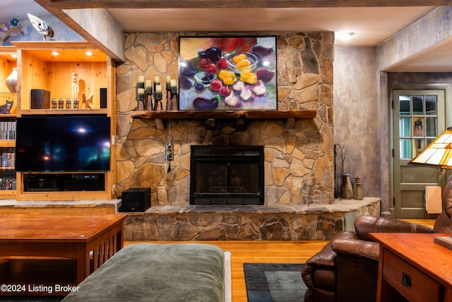 living room with a fireplace and hardwood / wood-style flooring