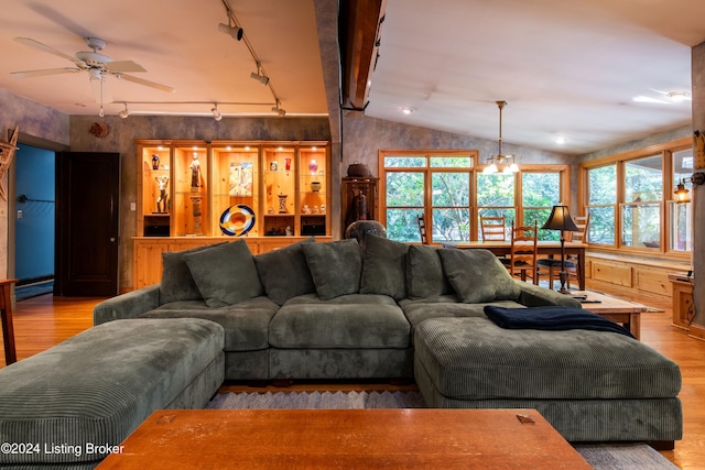 living room featuring ceiling fan, rail lighting, light hardwood / wood-style flooring, and lofted ceiling with beams