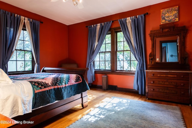 bedroom with hardwood / wood-style floors and ceiling fan