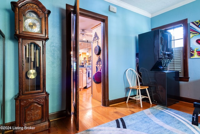 interior space with hardwood / wood-style flooring and crown molding