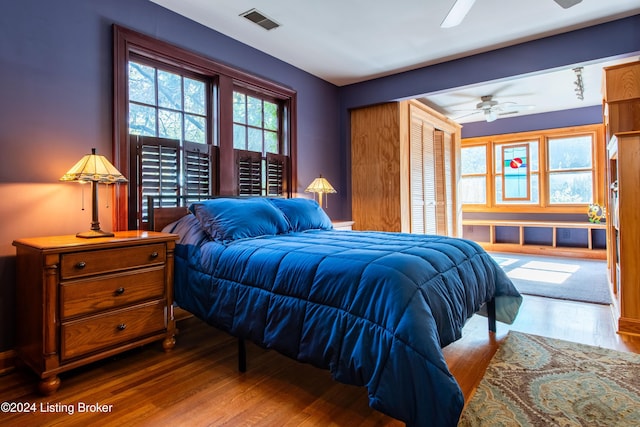 bedroom with a closet, wood-type flooring, and ceiling fan