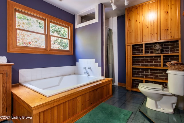 bathroom with tile patterned flooring, toilet, and independent shower and bath