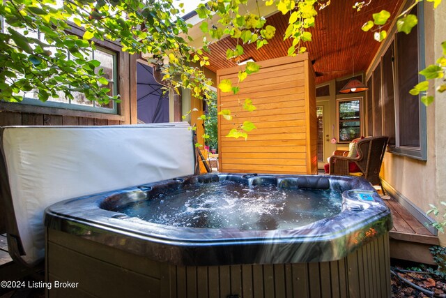 misc room with wood walls and a jacuzzi