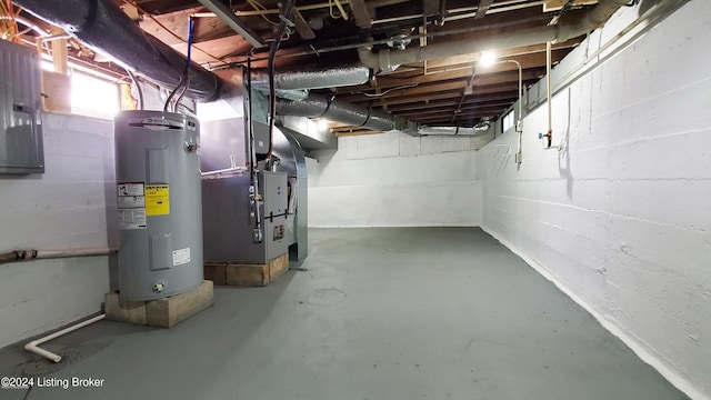 basement with electric water heater and heating unit