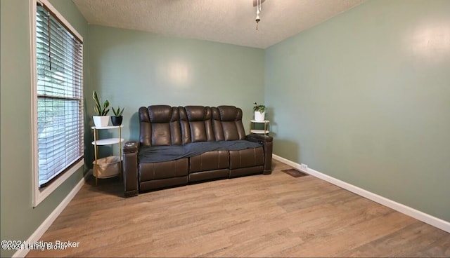 bedroom featuring light hardwood / wood-style floors and a textured ceiling