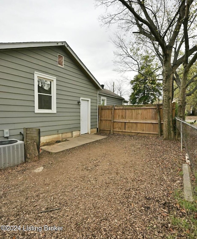 rear view of property featuring central AC unit