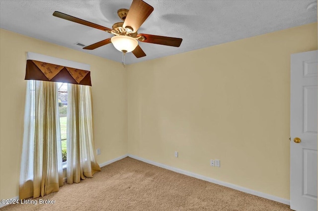 carpeted empty room with a textured ceiling and ceiling fan