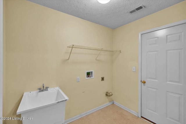 laundry room with sink, hookup for a washing machine, a textured ceiling, and hookup for an electric dryer