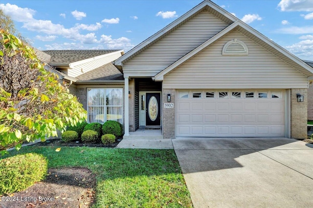 view of front of house with a garage and a front yard