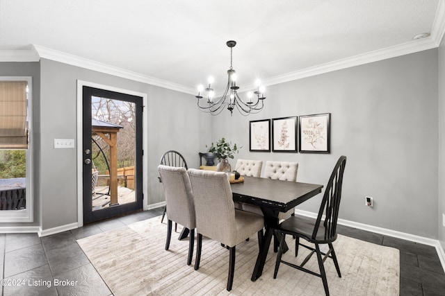 dining area featuring a notable chandelier, crown molding, and a wealth of natural light