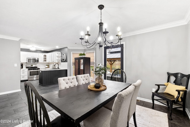 dining space with sink, crown molding, and a chandelier