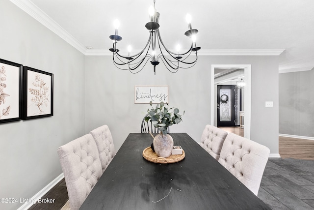 dining space with dark hardwood / wood-style floors, crown molding, and an inviting chandelier