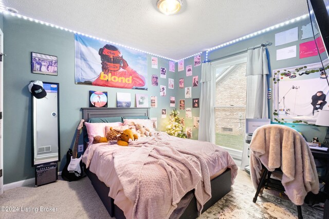 carpeted bedroom with a textured ceiling