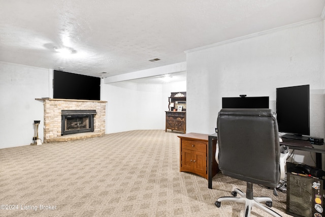 carpeted home office with a fireplace, a textured ceiling, and ornamental molding