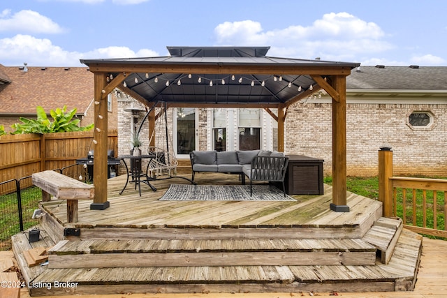 wooden terrace featuring a gazebo, outdoor lounge area, and grilling area