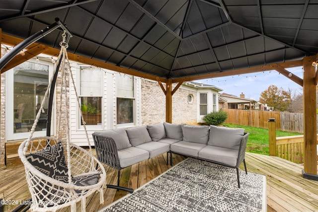 wooden deck with a gazebo and an outdoor hangout area