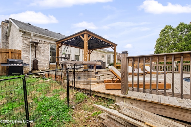 deck with grilling area and a hot tub