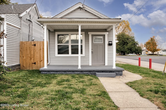 bungalow-style house featuring a porch and a front yard