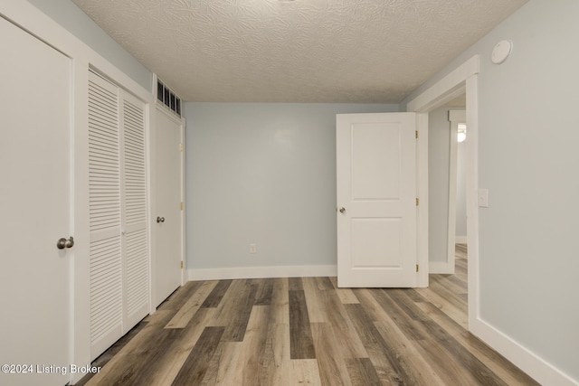 interior space featuring hardwood / wood-style floors and a textured ceiling