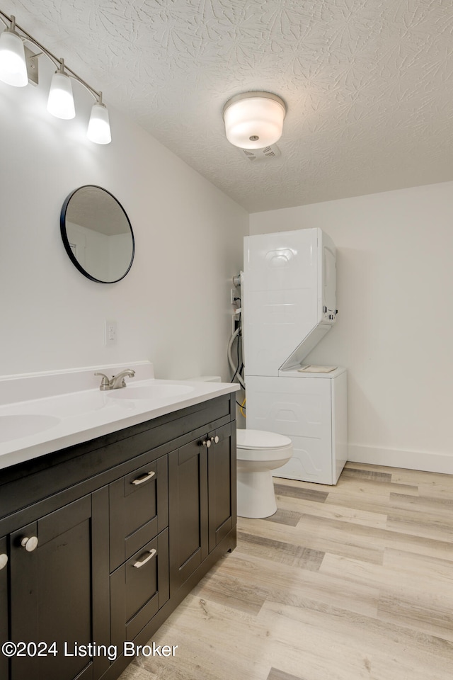 bathroom featuring hardwood / wood-style floors, a textured ceiling, toilet, and vanity