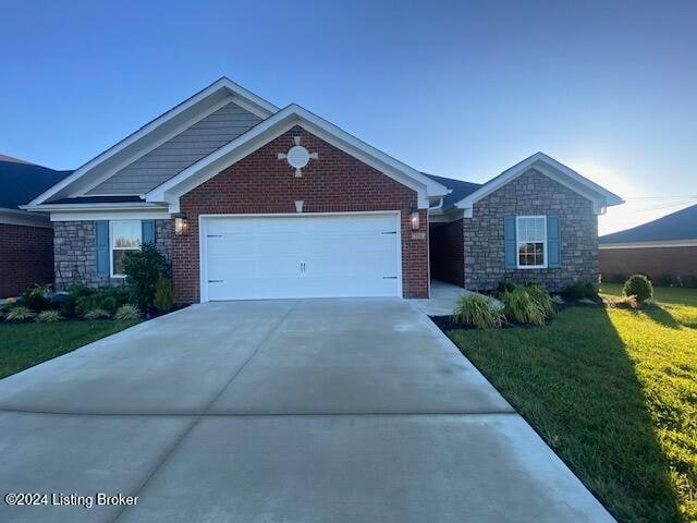 view of front of home featuring a garage and a front lawn