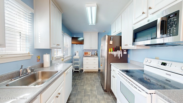 kitchen featuring white cabinets, stainless steel appliances, and sink