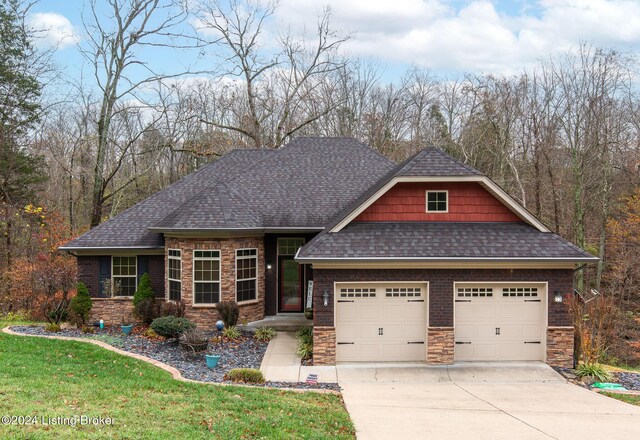 304 Hidden Falls Dr, Mt Washington, KY 40047 - craftsman house featuring a shingled roof, concrete driveway, stone siding, a garage, and a front lawn