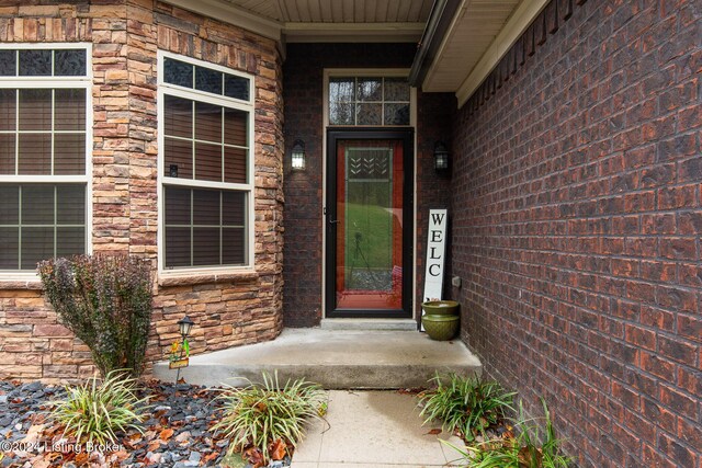 304 Hidden Falls Dr, Mt Washington, KY 40047 - view of exterior entry featuring stone siding, a porch, and brick siding