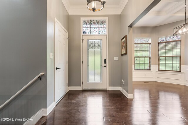 304 Hidden Falls Dr, Mt Washington, KY 40047 - foyer entrance featuring healthy amount of natural light, ornamental molding, dark wood finished floors, wainscoting, and a chandelier