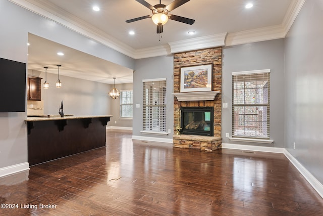 unfurnished living room with a fireplace, dark hardwood / wood-style floors, and ornamental molding