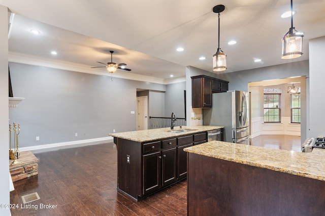 kitchen with dark hardwood / wood-style flooring, sink, decorative light fixtures, and dark brown cabinets