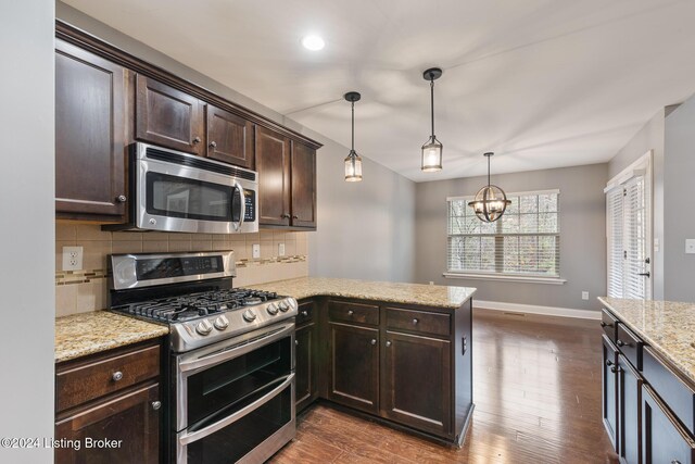 304 Hidden Falls Dr, Mt Washington, KY 40047 - kitchen with stainless steel appliances, dark brown cabinets, a peninsula, backsplash, and baseboards
