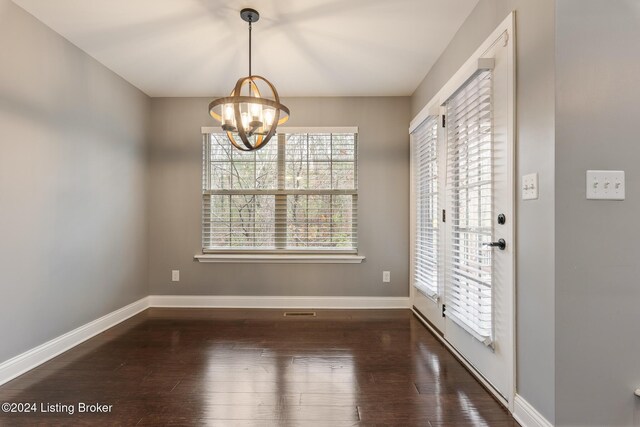 304 Hidden Falls Dr, Mt Washington, KY 40047 - unfurnished dining area featuring wood-type flooring, baseboards, and a chandelier