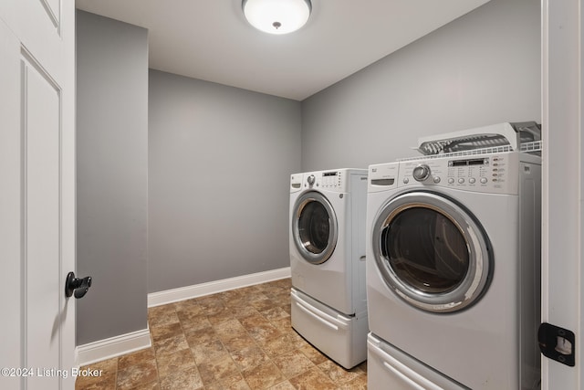 clothes washing area with washing machine and dryer