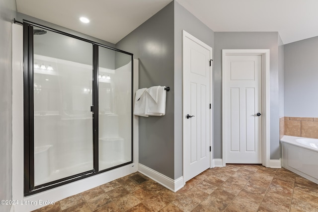 bathroom featuring independent shower and bath