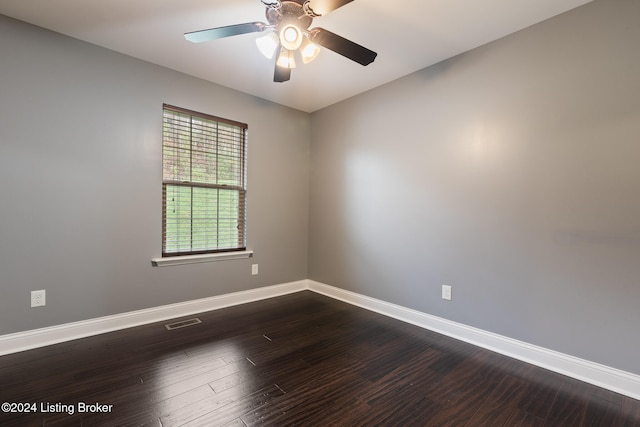 empty room with ceiling fan and dark hardwood / wood-style floors