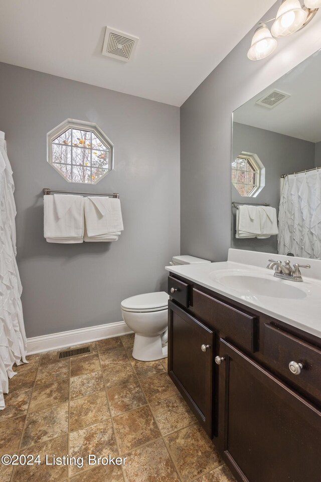 304 Hidden Falls Dr, Mt Washington, KY 40047 - full bathroom with vanity, toilet, baseboards, and stone finish floors