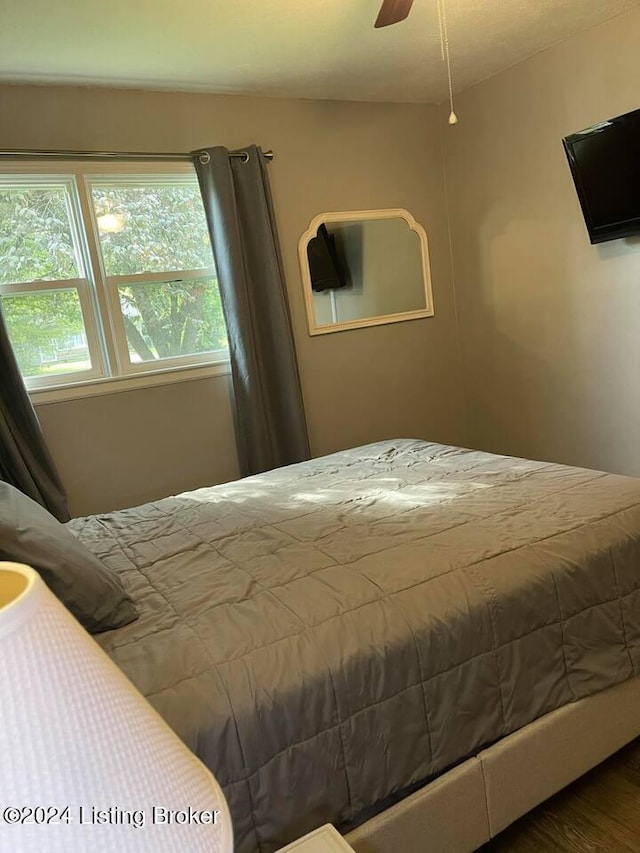 bedroom with ceiling fan and wood-type flooring