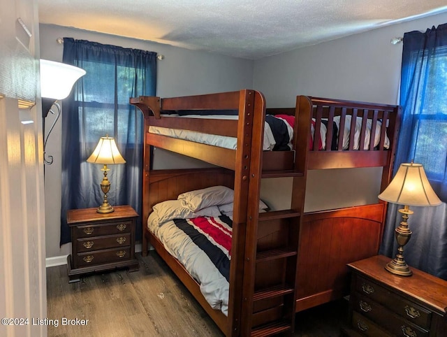 bedroom with wood-type flooring and a textured ceiling