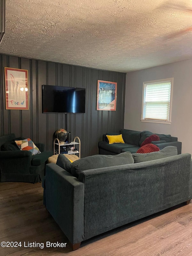 living room featuring hardwood / wood-style flooring and a textured ceiling