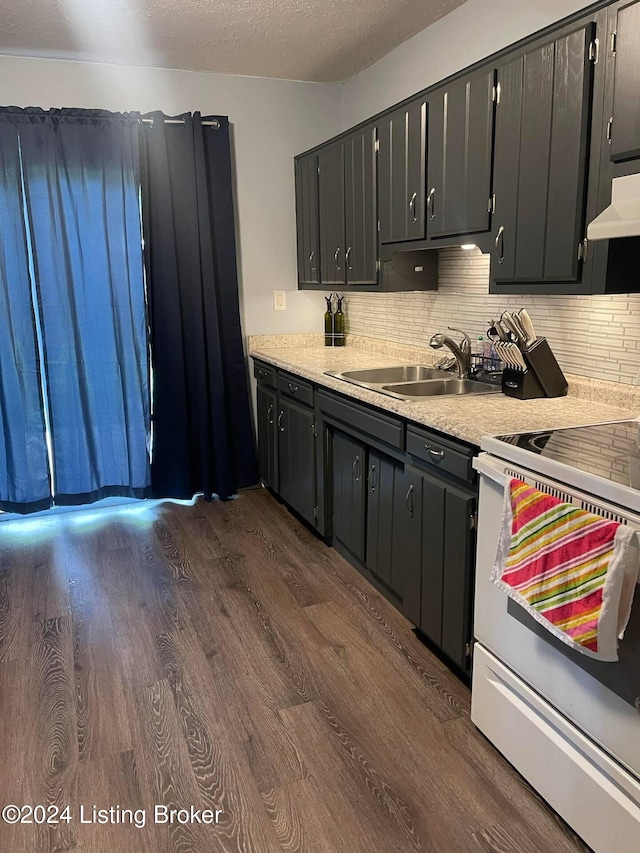 kitchen featuring white range with electric cooktop, backsplash, dark hardwood / wood-style flooring, and sink