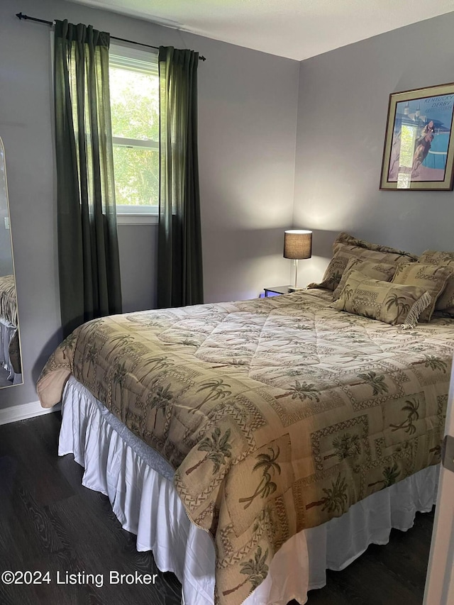 bedroom with dark wood-type flooring