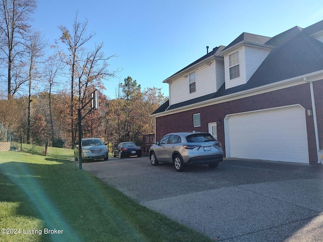 view of home's exterior with a yard and a garage