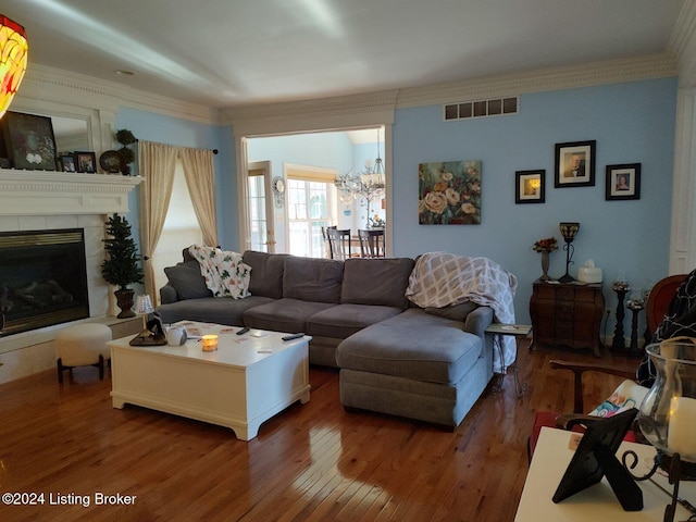 living room with a fireplace, dark hardwood / wood-style flooring, and ornamental molding