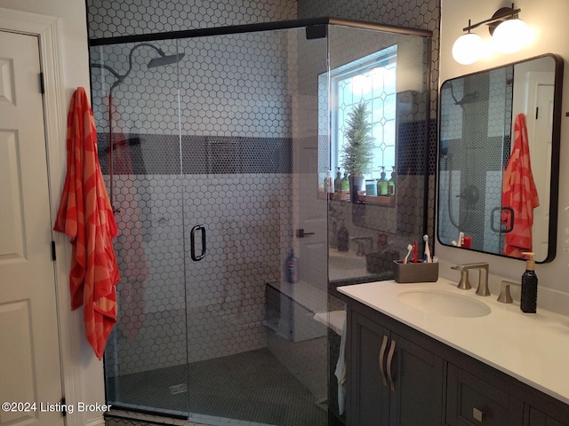 bathroom with vanity and a shower with shower door