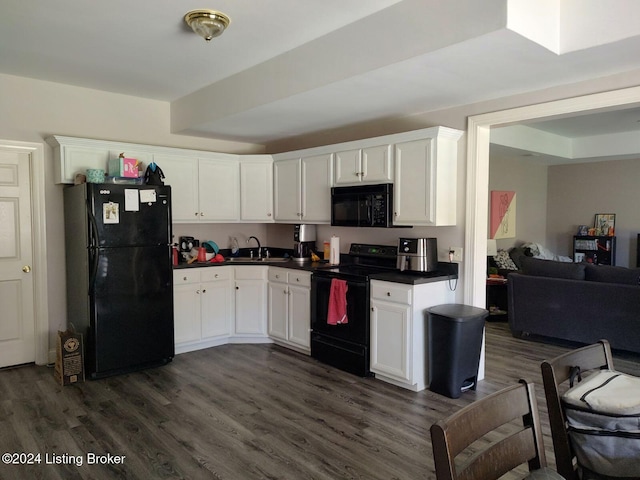 kitchen with black appliances, sink, white cabinets, and dark wood-type flooring