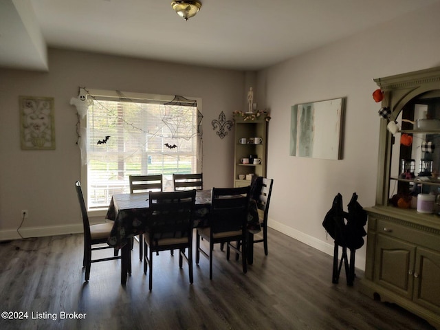 dining space with dark hardwood / wood-style flooring